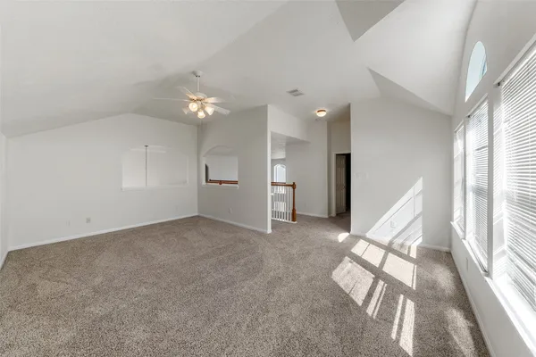 a living room with furniture a flat screen tv and a window