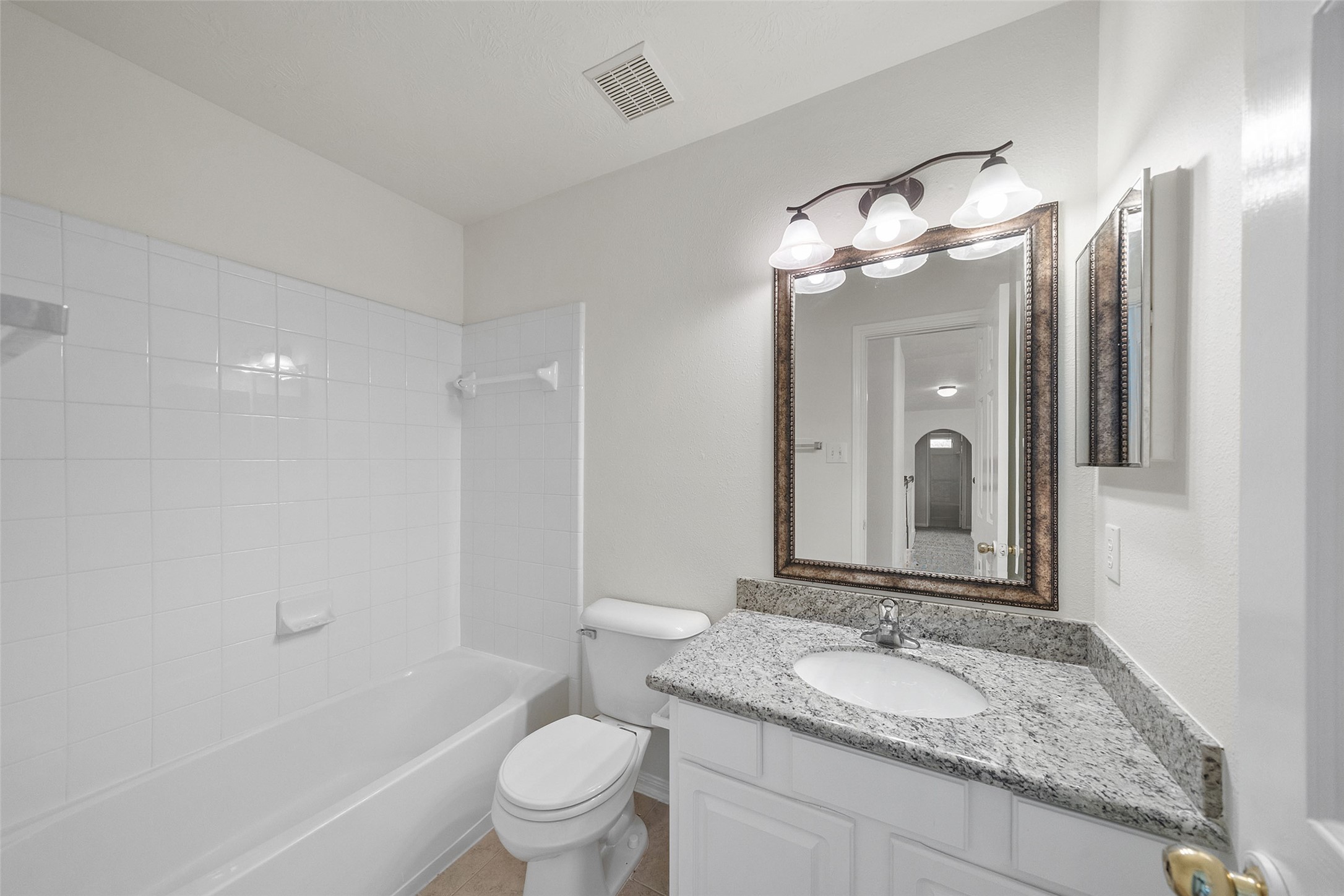 14213 Stone Bluff Lane Rosharon, TX 77583 - Photo 36 of 45 a bathroom with a granite countertop sink toilet mirror and shower