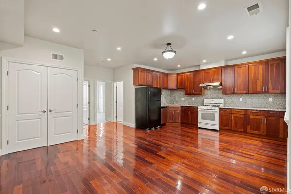 a kitchen with stainless steel appliances granite countertop a refrigerator and a sink
