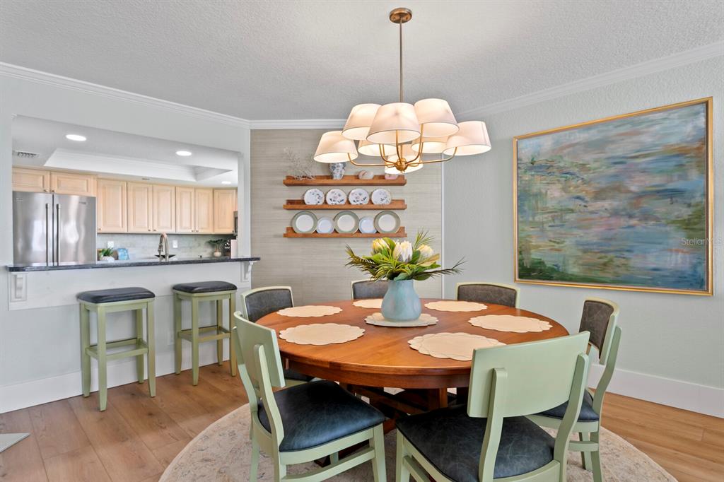 16332 Gulf Boulevard, Unit 3B Redington Beach, FL 33708 - Photo 26 of 93 a view of a dining room with furniture a chandelier and wooden floor