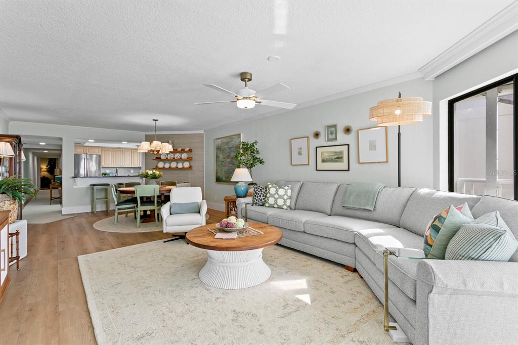 16332 Gulf Boulevard, Unit 3B Redington Beach, FL 33708 - Photo 32 of 93 a living room with furniture a fireplace and a chandelier