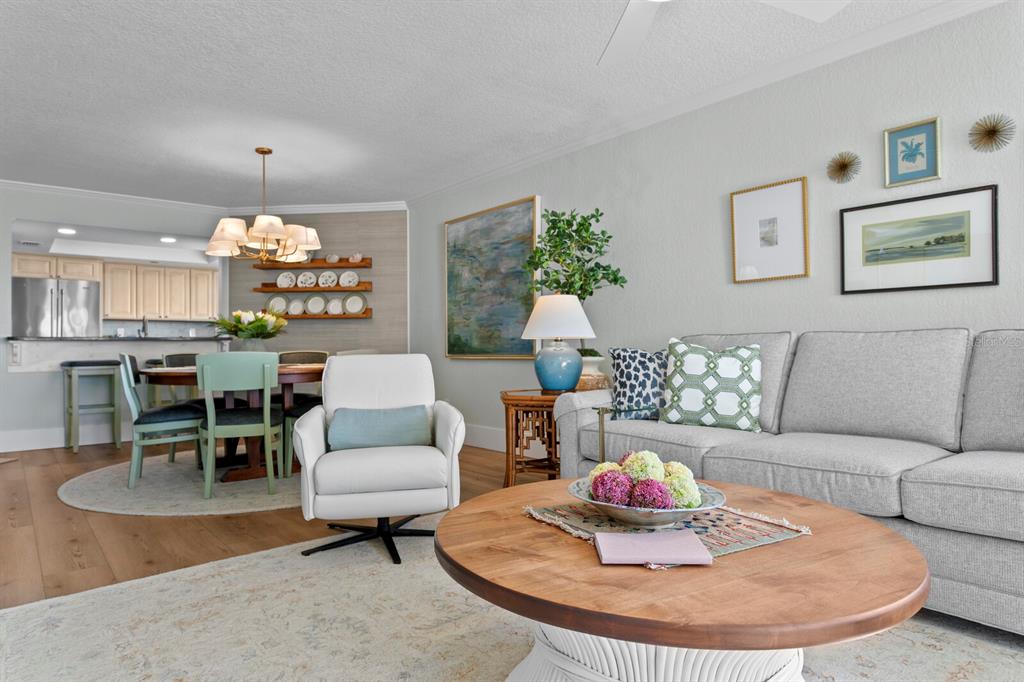 16332 Gulf Boulevard, Unit 3B Redington Beach, FL 33708 - Photo 33 of 93 a living room with furniture and a chandelier