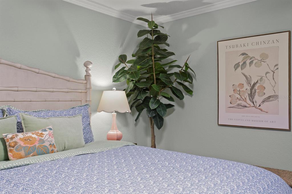 16332 Gulf Boulevard, Unit 3B Redington Beach, FL 33708 - Photo 37 of 93 a bedroom with a bed and a potted plant