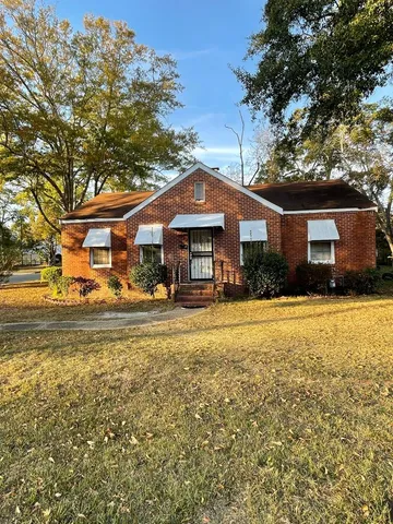 a front view of a house with a yard