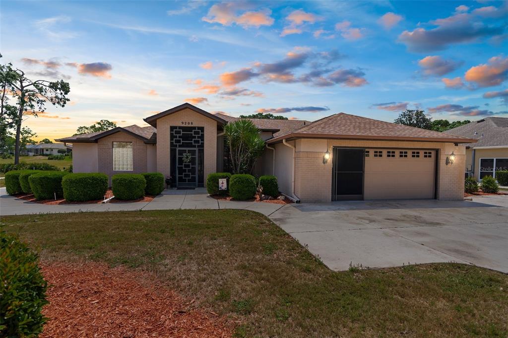 9208 Butler Boulevard Weeki Wachee, FL 34613 - Photo 1 of 1 a front view of a house with a garden
