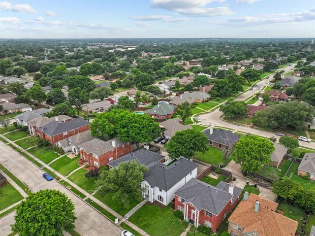 an aerial view of residential houses with outdoor space