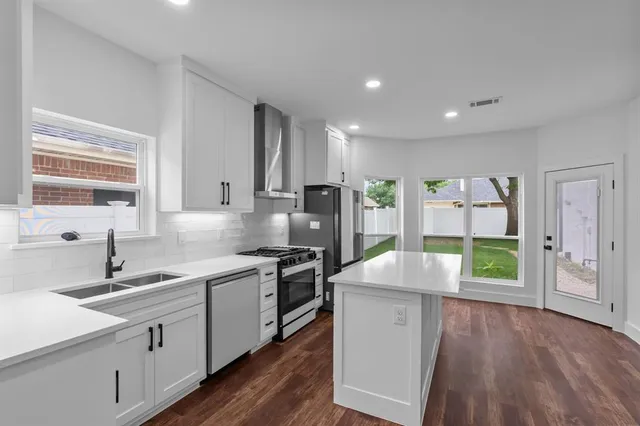a kitchen with a sink stove and cabinets