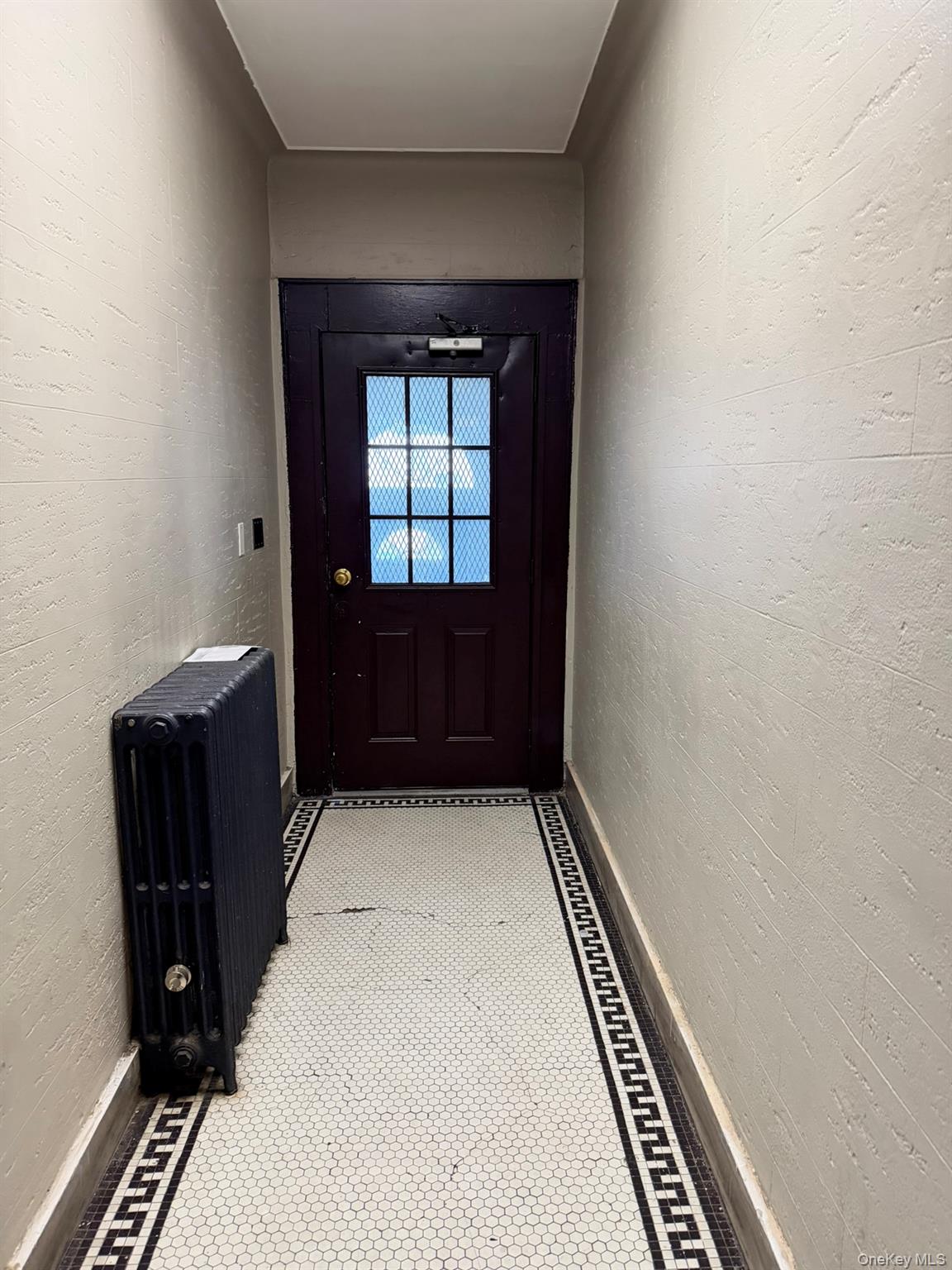 100-04 Spruce Street Queens, NY 11368 - Photo 3 of 12 a bedroom with a bed and a window