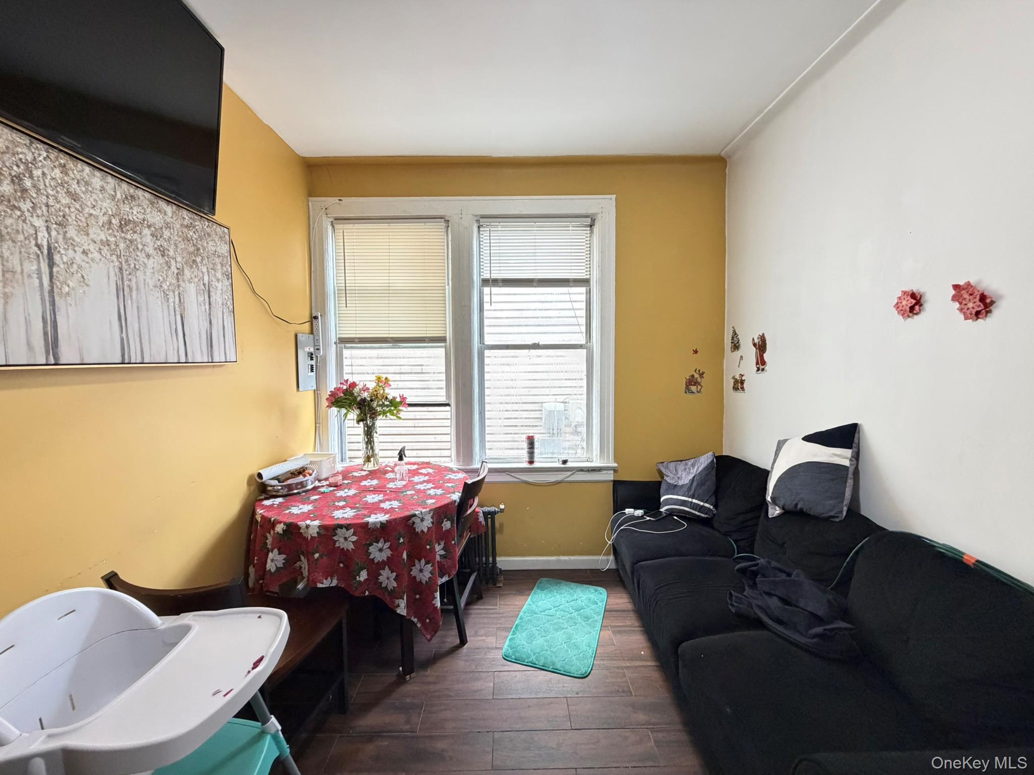 100-04 Spruce Street Queens, NY 11368 - Photo 6 of 12 a bedroom with a bed and wooden floor