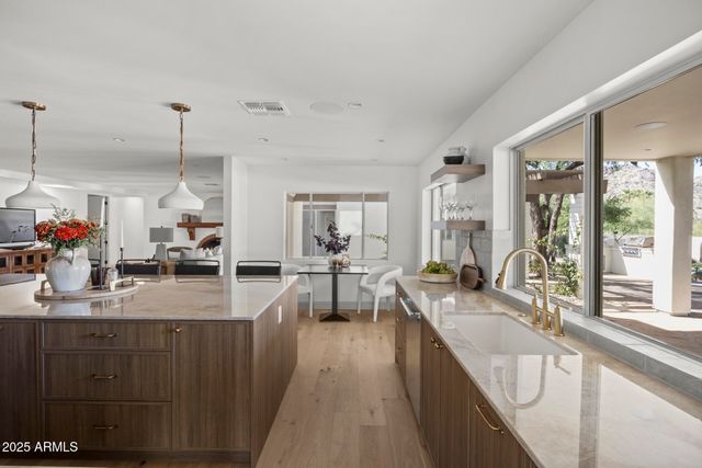 a kitchen with sink refrigerator and large window
