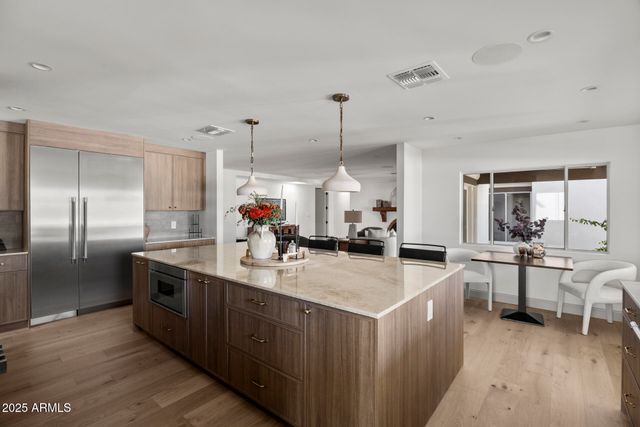 a kitchen with stainless steel appliances granite countertop a sink stove and refrigerator