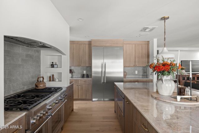 a kitchen with stainless steel appliances granite countertop a sink and cabinets