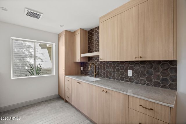 a kitchen with a sink and cabinets