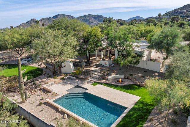 an aerial view of a house with a yard