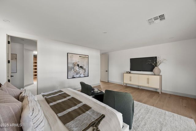 a bedroom with a bed and a television