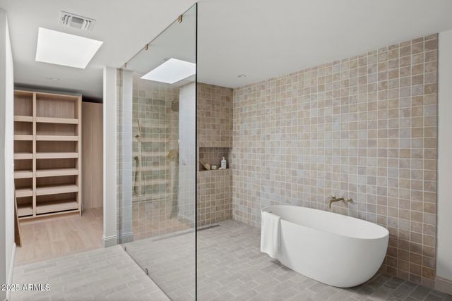 a bathroom with a bathtub and shower