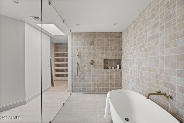 a bathroom with a bathtub and shower