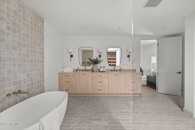 a bathroom with a sink a toilet and mirror