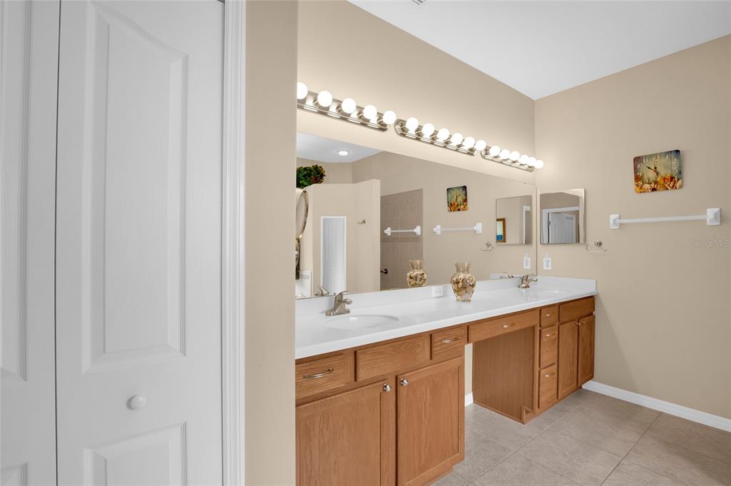 16411 Southwest 14th Avenue Road Ocala, FL 34473 - Photo 16 of 59 a spacious bathroom with a double vanity and a mirror