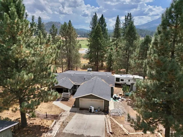 an aerial view of a houses with yard