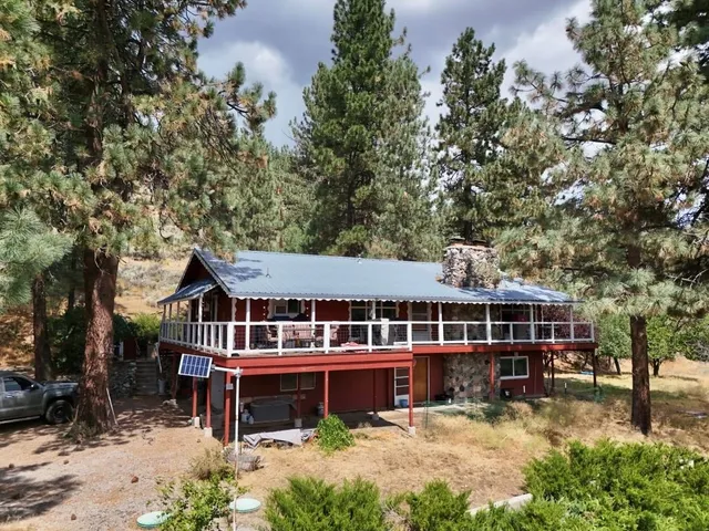 aerial view of a house with a yard deck and a garden