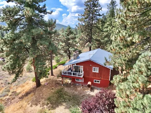 a view of a house with a tree in the background