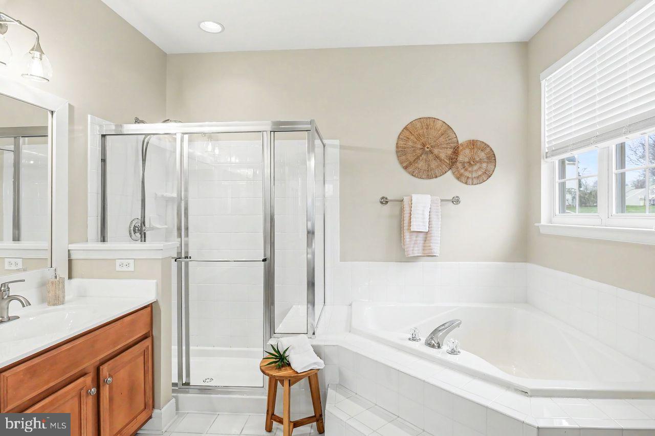 35 Vista Loop Hanover, PA 17331 - Photo 24 of 37 a bathroom with a tub a sink and a large mirror