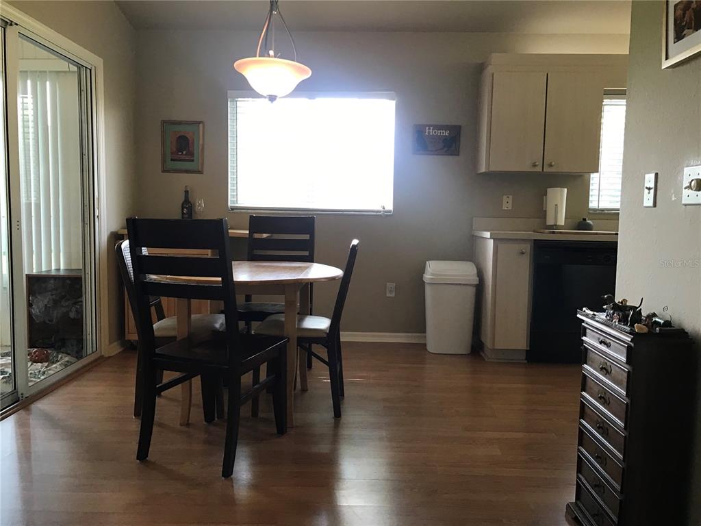 11879 Southwest 137th Loop Dunnellon, FL 34432 - Photo 21 of 37 a kitchen with a table chairs and a window