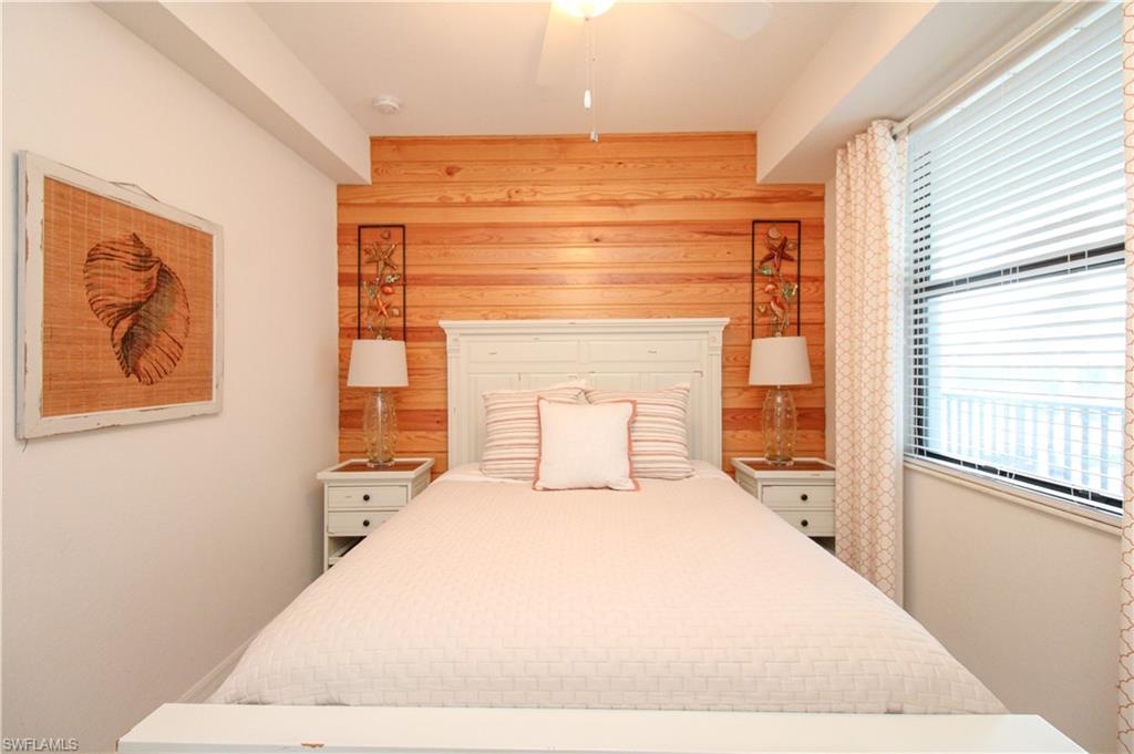 9554 Trevi Court, Unit 4737 Naples, FL 34113 - Photo 11 of 49 a bedroom with a bed and a large window