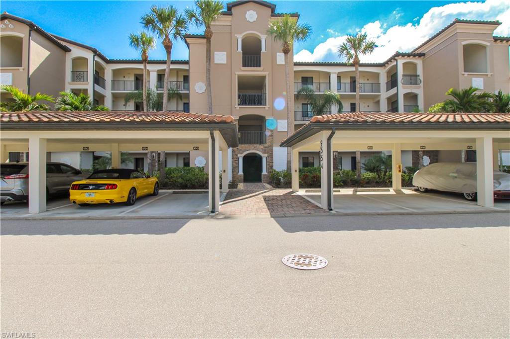 9554 Trevi Court, Unit 4737 Naples, FL 34113 - Photo 2 of 49 a view of a building with car parked