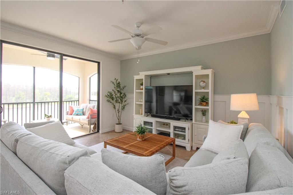 9554 Trevi Court, Unit 4737 Naples, FL 34113 - Photo 21 of 49 a living room with furniture and a flat screen tv