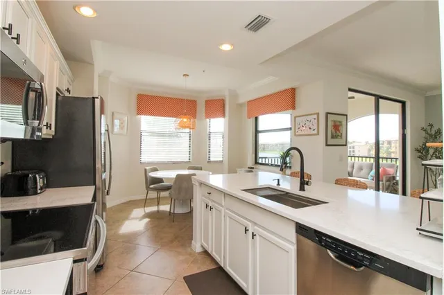 a kitchen with stainless steel appliances a sink a stove and a microwave