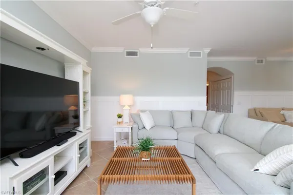 a living room with furniture and kitchen view