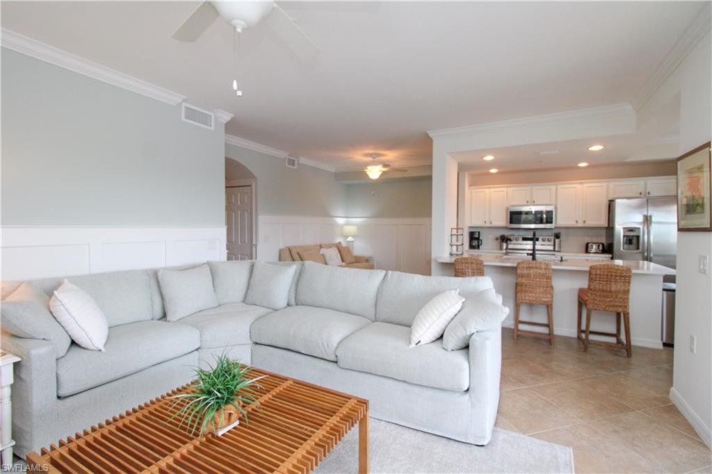 9554 Trevi Court, Unit 4737 Naples, FL 34113 - Photo 34 of 49 a living room with furniture and kitchen view