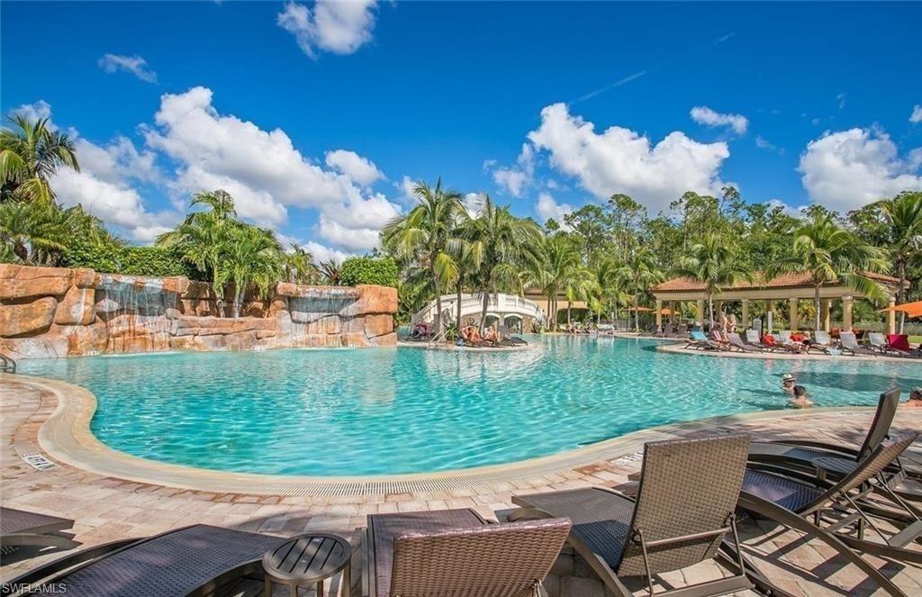 9554 Trevi Court, Unit 4737 Naples, FL 34113 - Photo 43 of 49 a view of a swimming pool with a patio