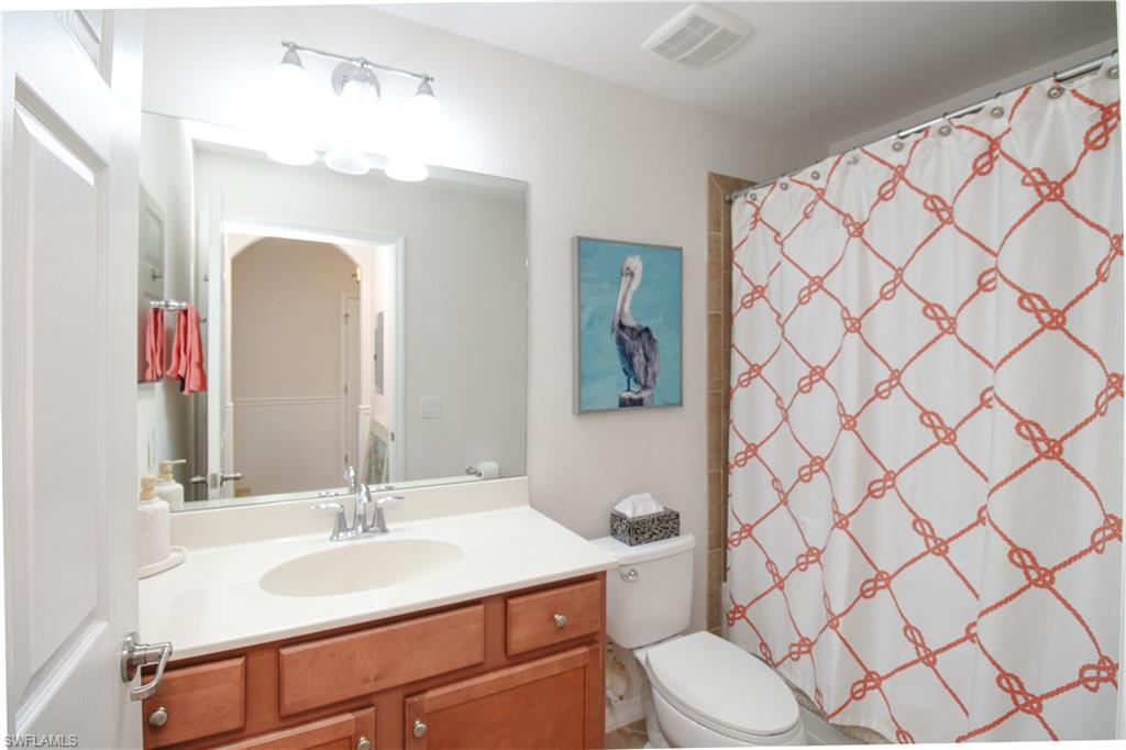 9554 Trevi Court, Unit 4737 Naples, FL 34113 - Photo 8 of 49 a bathroom with a sink vanity mirror and toilet