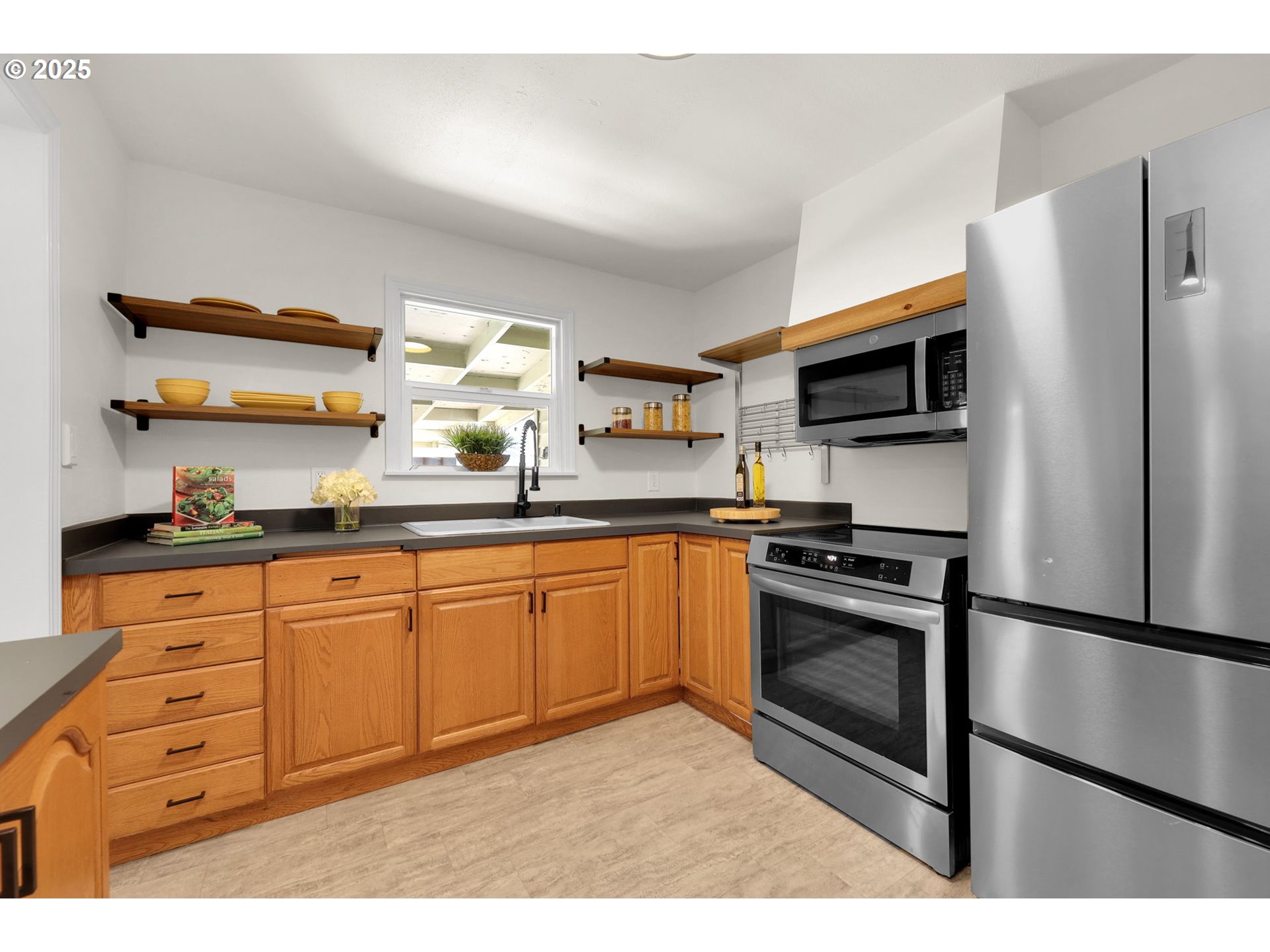 830 Jerry Street Eugene, OR 97402 - Photo 10 of 22 a kitchen with stainless steel appliances granite countertop a refrigerator a stove a sink and a microwave