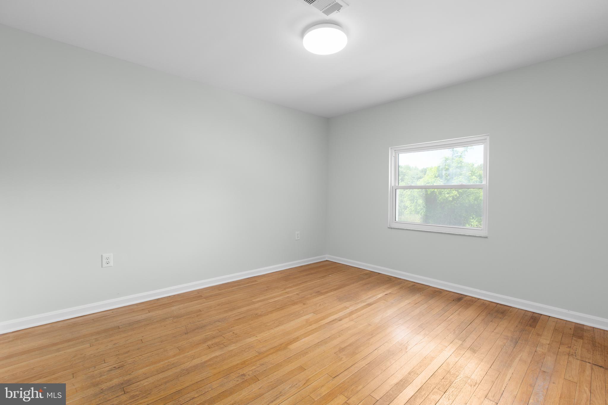 10827 Catharpin Road Spotsylvania, VA 22553 - Photo 24 of 39 an empty room with wooden floor and windows