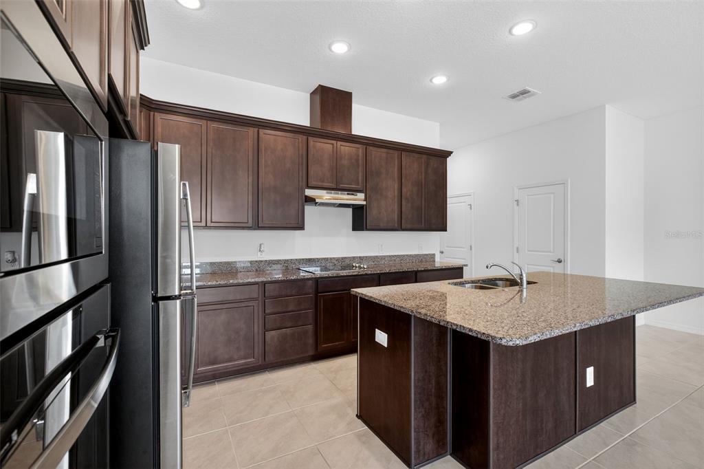 810 MIDDLETON Street DeBary, FL 32713 - Photo 6 of 52 a kitchen with a sink stove and refrigerator