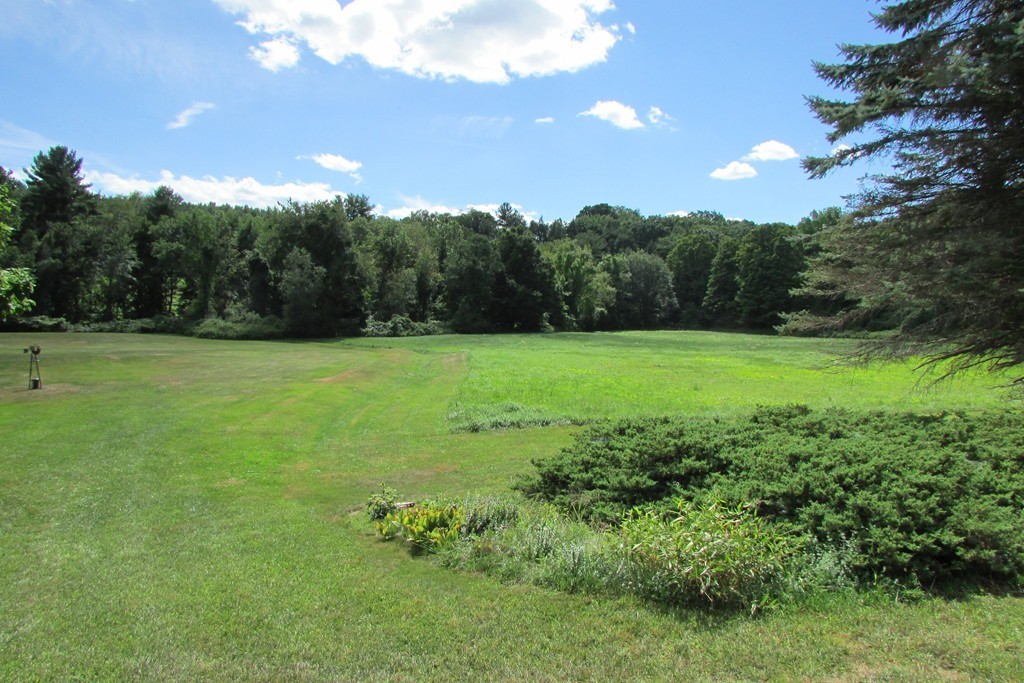 75 Stage Road Westhampton, MA 01027 - Photo 9 of 30 a view of a grassy field with trees in the background