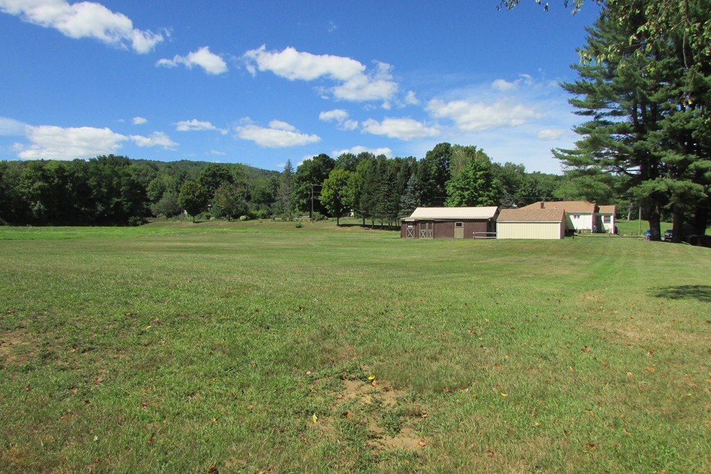 75 Stage Road Westhampton, MA 01027 - Photo 10 of 30 a view of a green field with sunset in the background