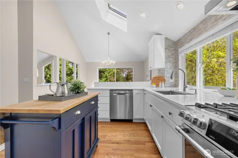 a kitchen with sink stove and cabinets