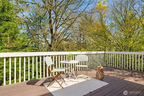 a view of balcony with wooden floor and fence
