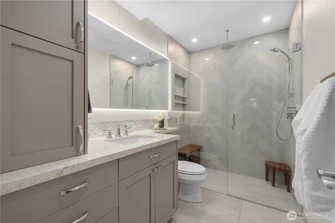 a bathroom with a double vanity sink toilet and shower