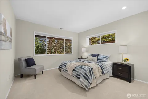 a bedroom with a bed and a painting on the wall