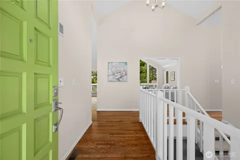 a view of a hallway with wooden floor and entryway