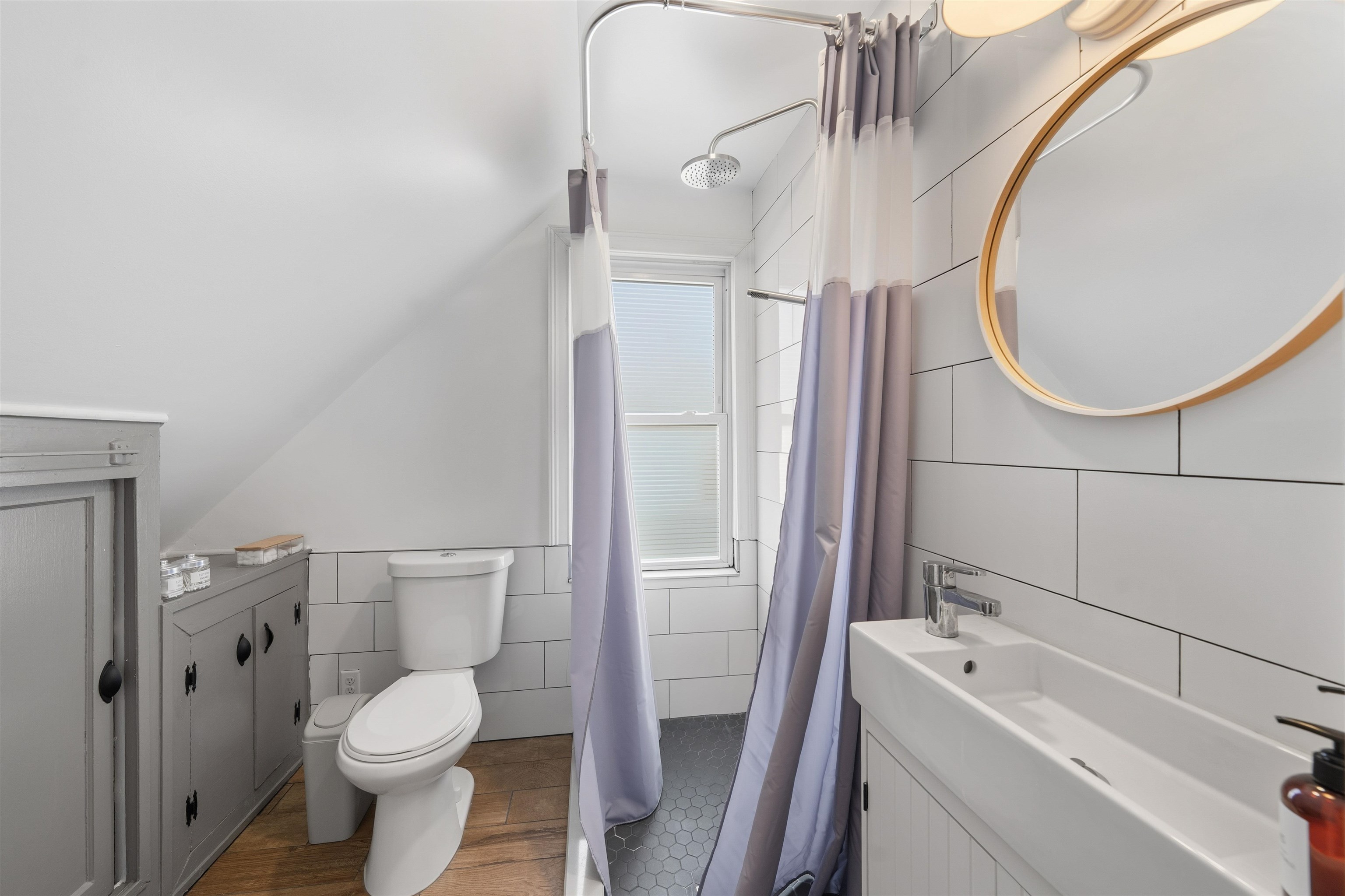 124 73rd Street, Unit 3 North Bergen, NJ 07047 - Photo 11 of 14 a bathroom with a sink a toilet and a mirror