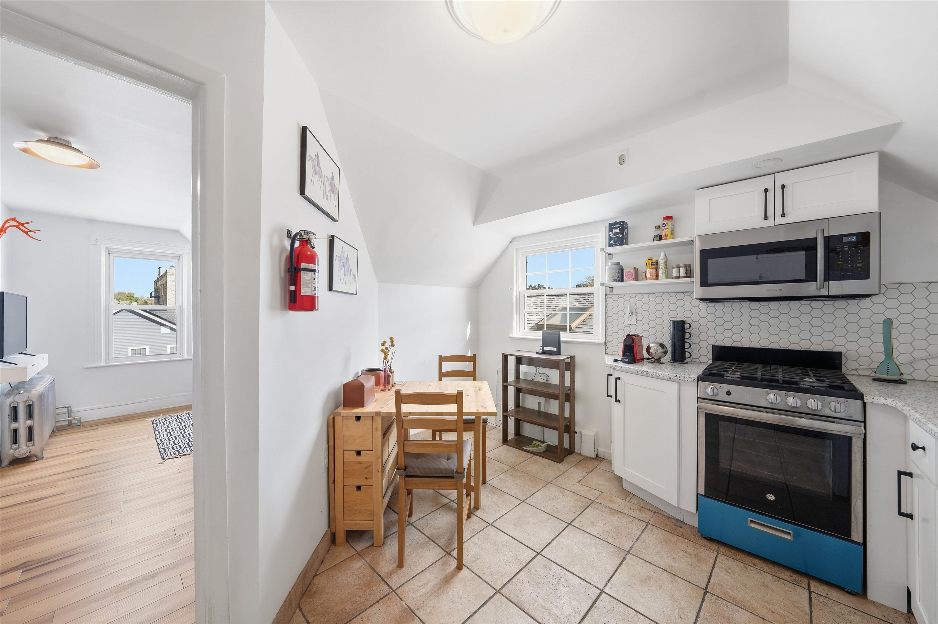 124 73rd Street, Unit 3 North Bergen, NJ 07047 - Photo 5 of 14 a kitchen with stainless steel appliances a stove a sink cabinets and a refrigerator
