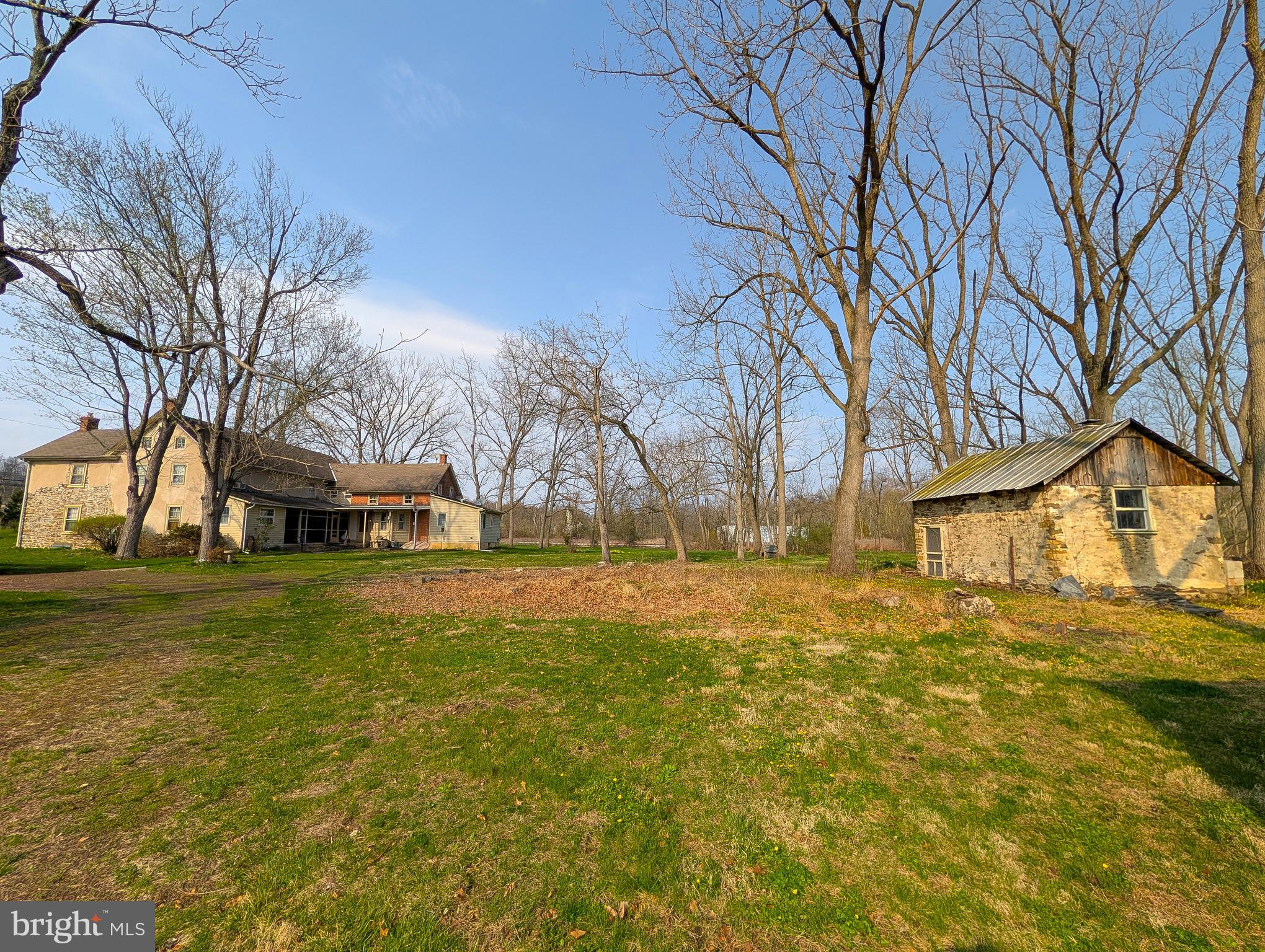 173 Township Line Road Line Lexington, PA 18932 - Photo 4 of 7 a yellow house in middle of forest