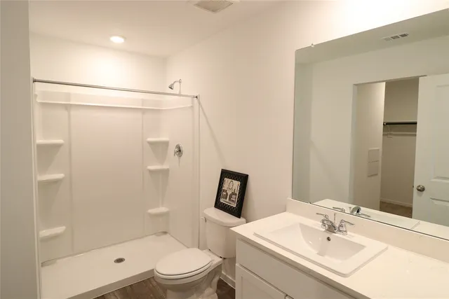 a bathroom with a sink toilet and shower